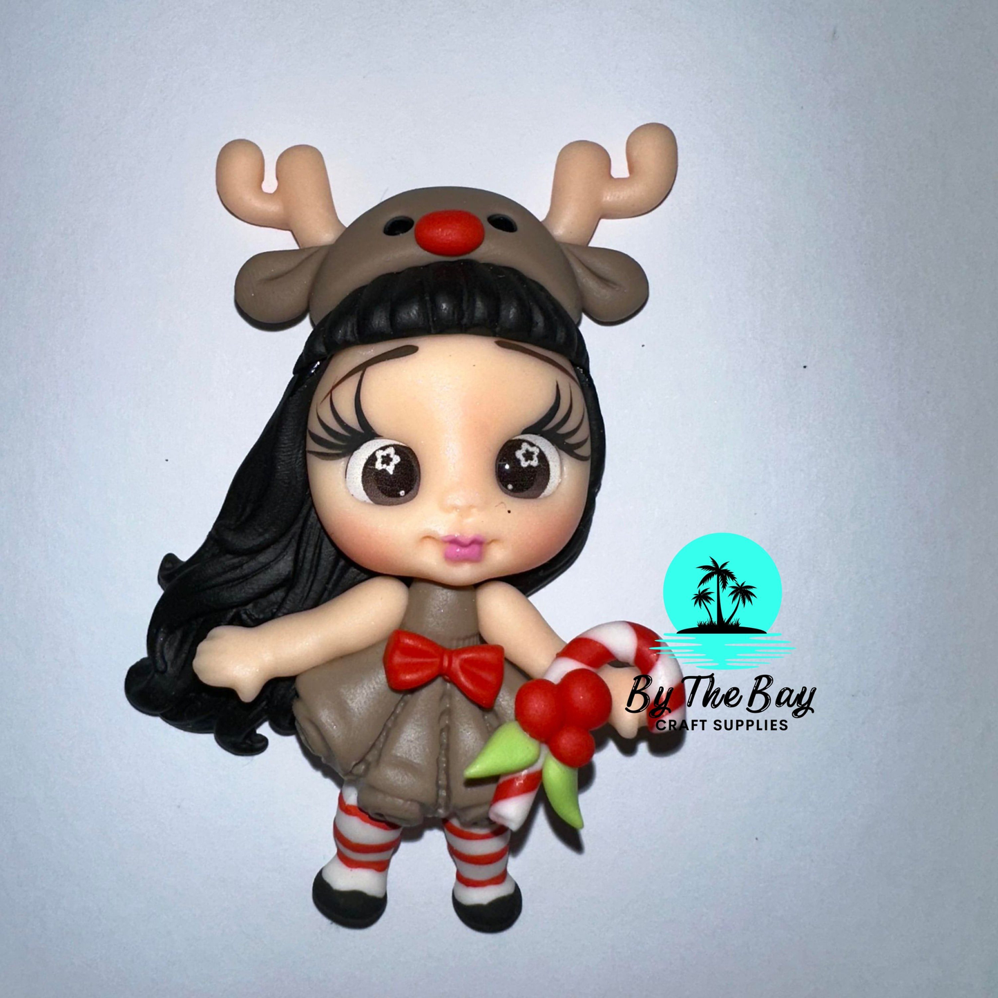 Girl dressed in deer costume with candy cane